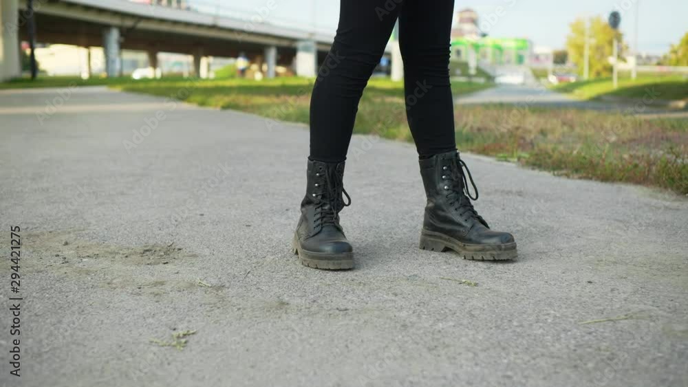 Teenager Stand Motionlessly Feet View City Street. Person Stock-still Position Black Lace-boots Wear Immobility Pose. Leather Footwear Urban Asphalt Highway Background Lifestyle Concept Teenager Stand Motionlessly Feet View City Street. Person Stock-still Position Black Lace-boots Wear Immobility Pose. Leather Footwear Urban Asphalt Highway Background Lifestyle Concept