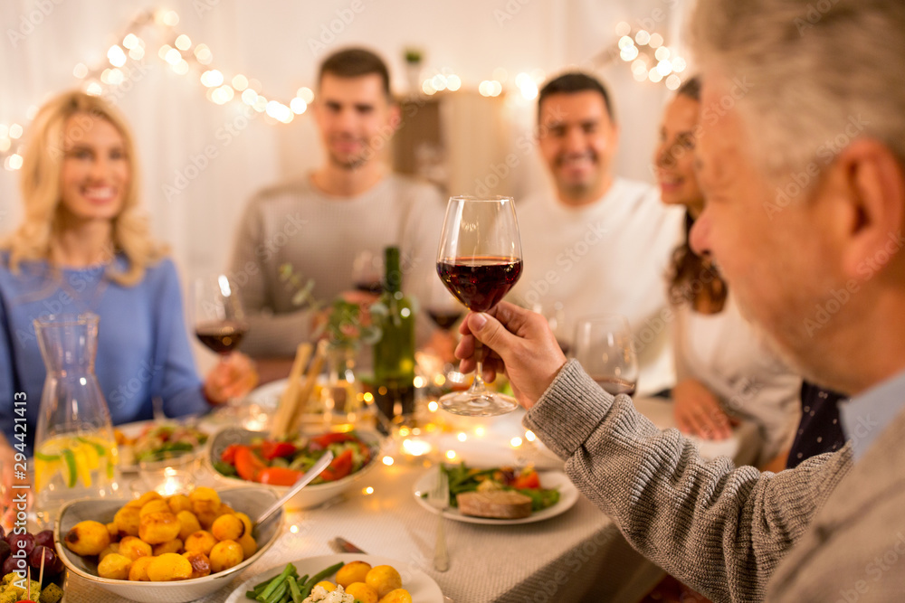 celebration, holidays and people concept - happy family having dinner party, drinking red wine and toasting at home