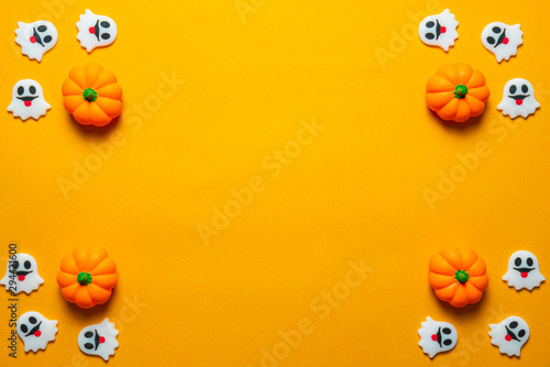 Halloween holiday concept, Spooky pumpkins and ghosts in orange background with copy space for text, Top flat view wallpaper