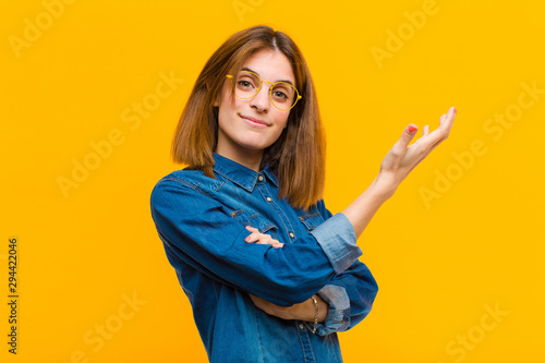 Canvas Print young pretty woman feeling confused and clueless, wondering about a doubtful exp