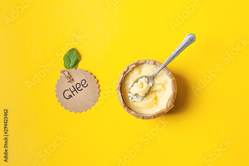 Homemade ghee in a jar, wrapped in parchment paper and an inscription sticker with a green leaf. Ayurveda photo