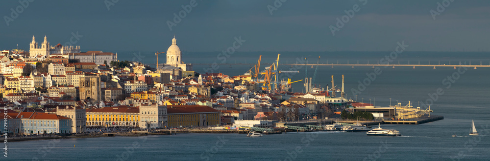 Aerial panorama of Lisbon old city center at sunset, view from Almada, Portugal