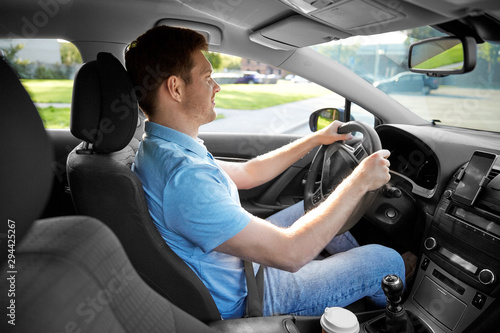 transport, vehicle and people concept - smiling man or driver driving car in summer