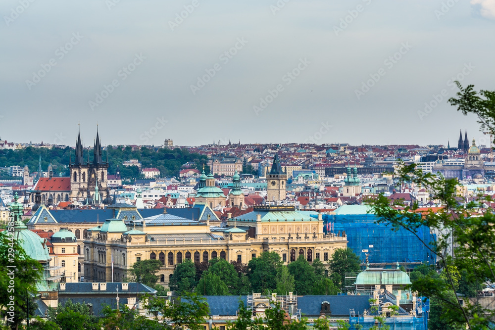 Aerial view of citycape of old town of Prague, with a lot of red rooftops and  The Church of Mother of God before Tyn, and the power tower. Gothic church and a dominant feature of the Old Town. 