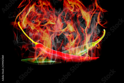 Chili burned to high heat. Two pieces  green and red  black background