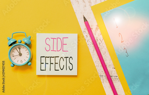 Conceptual hand writing showing Side Effects. Concept meaning secondary undesirable effect of a drug or medical treatment Notepads marker colored paper sheets alarm clock wooden background