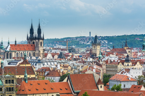 Aerial view of citycape of old town of Prague, with a lot of red rooftops and The Church of Mother of God before Týn, and the power tower.