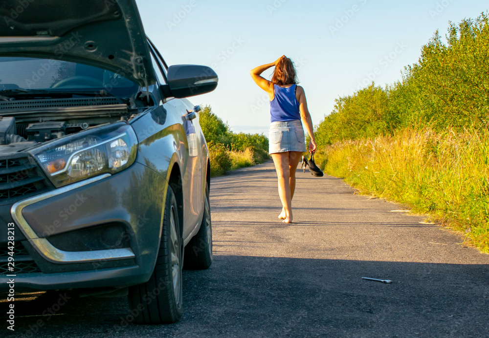Beautiful young girl, in despair, she can not continue her journey because of the fact that her car broke down. Beautiful young girl, in despair, she can not continue her journey because of the fact that her car broke down.