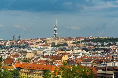 Aerial view of citycape of old town of Prague, with a lot of rooftops, churches, and the landmark of Television Tower. view from the Letna park.