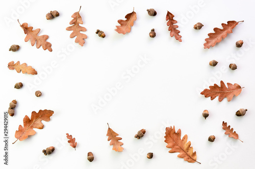 autumn is coming concept. Flat lay Frame of dry fallen autumn leaves, chestnuts, acorns isolated on white with copy space
