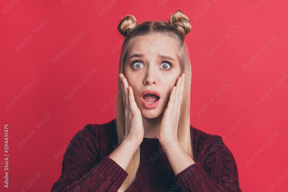 Closeup photo of pretty lady holding arms on cheekbones open mouth not believe eyes awful epic fail wear burgundy knitted pullover isolated pastel red color background Closeup photo of pretty lady holding arms on cheekbones open mouth not believe eyes awful epic fail wear burgundy knitted pullover isolated pastel red color background