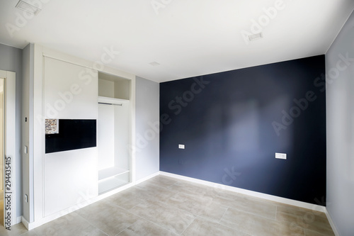 White and Blue empty room with built-in wardrobes. Interior modern room.