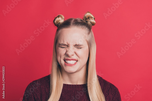 Close up photo of scared anticipating afraid terrified girl with stressed facial expression making mistake isolated over red vivid color background photo