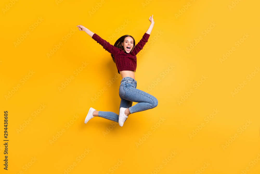 Full length photo of charming cute girl raising her hands screaming wearing burgundy sweater isolated over yellow background - obrazy, fototapety, plakaty 
