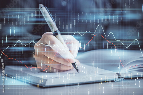 Double exposure of woman's hands making notes with forex graph hologram. Concept technical analysis. © peshkova
