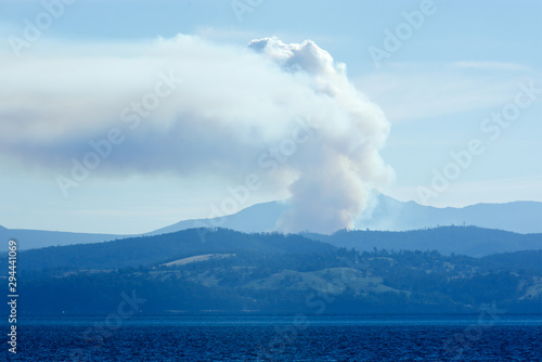 Hobart bush fire with smoke arising as seen from Bruny Island, Tasmania, Australia