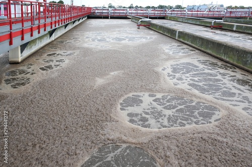 Sewage covered with thick brown foamed slurries (in sewage treatment plant) - texture