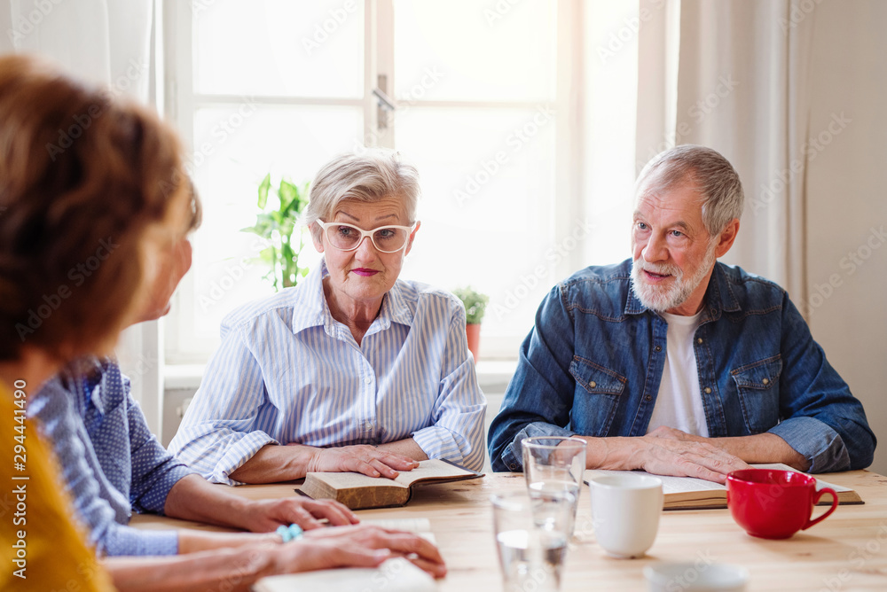 Senior people in bible reading group in community center club. Senior people in bible reading group in community center club.