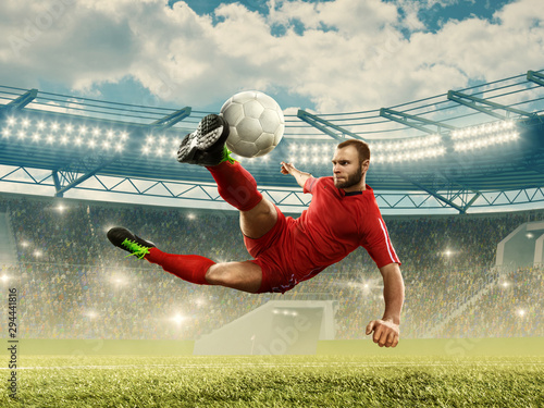 Soccer player in action on a stadium. Soccer championship. Stadium with fans © TandemBranding