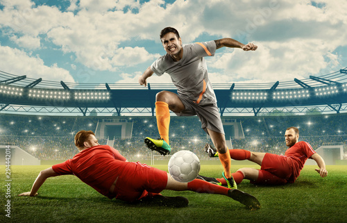 Soccer player fighting for the ball with defence players. Action. Soccer field with green grass © TandemBranding