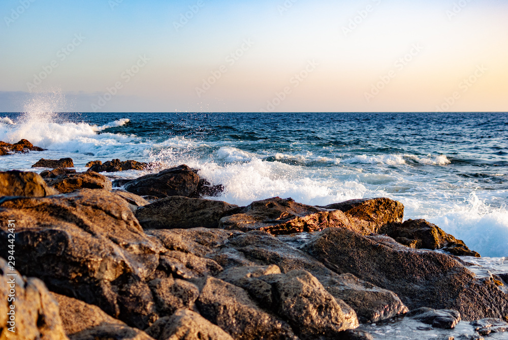 waves of the atlantic ocean, stone coast, evening sunlight