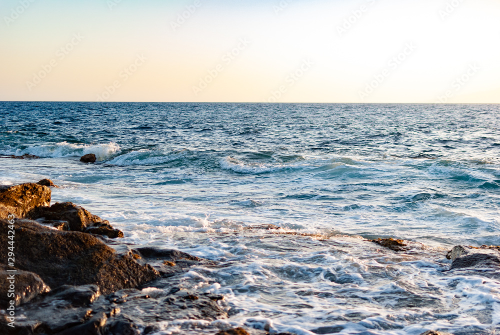 Fototapeta premium ocean waves cover a stone coast