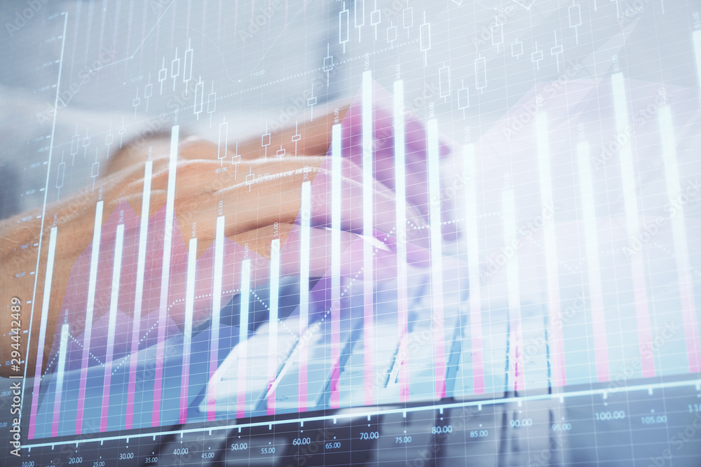 Multi exposure of graph with man typing on computer in office on background. Concept of hard work. Closeup. Multi exposure of graph with man typing on computer in office on background. Concept of hard work. Closeup.