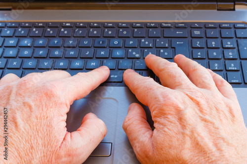 Photography a man works at the computer/hands of a man working at the computer