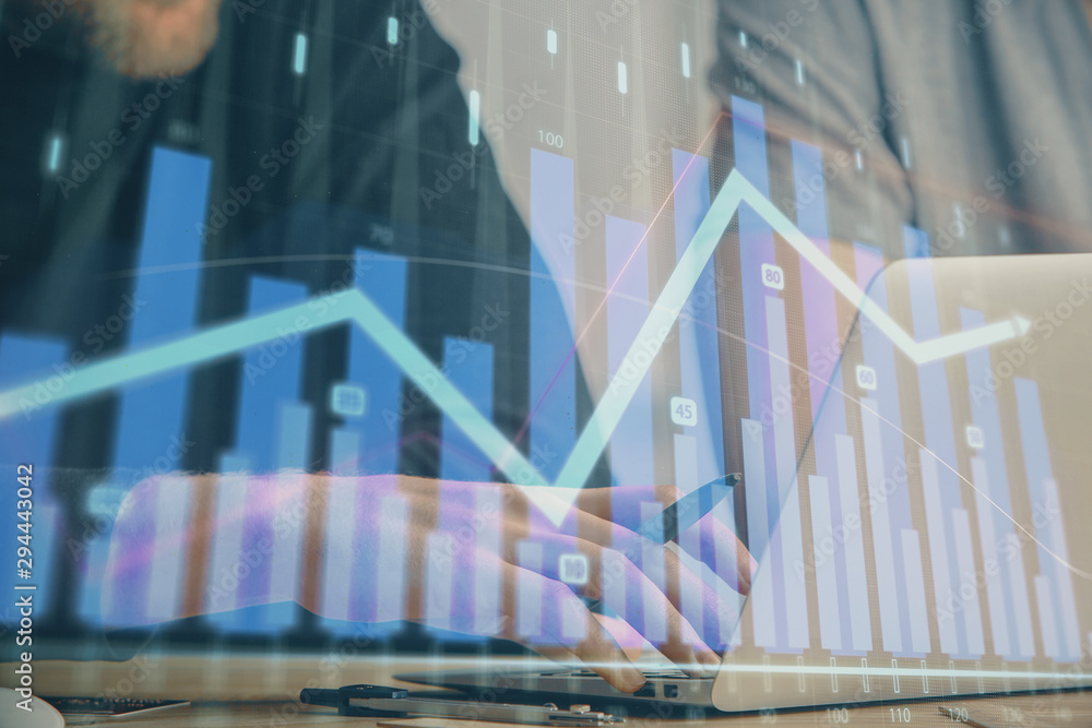 Forex graph with businessman typing on computer in office on background. Concept of analysis. Double exposure. Forex graph with businessman typing on computer in office on background. Concept of analysis. Double exposure.