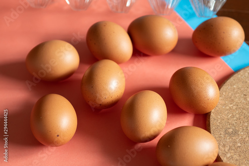 Chicken eggs on pink background