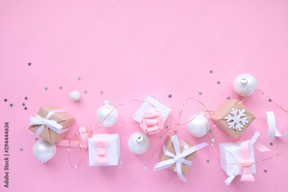 Christmas background with decorations and gift boxes on pink background Christmas background with decorations and gift boxes on pink background