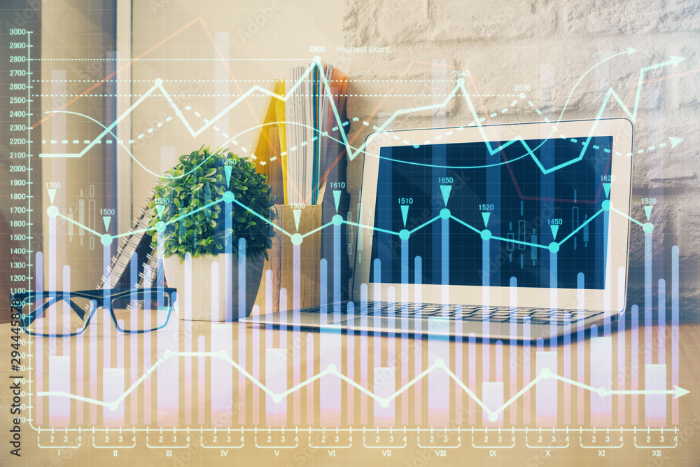 Financial graph colorful drawing and table with computer on background. Double exposure. Concept of international markets. Financial graph colorful drawing and table with computer on background. Double exposure. Concept of international markets.