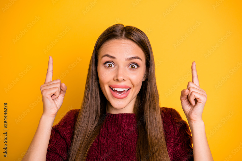 Portrait of astonished lady raising her fingers screaming wow omg wearing burgundy sweater isolated over yellow background Portrait of astonished lady raising her fingers screaming wow omg wearing burgundy sweater isolated over yellow background