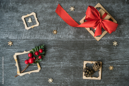 christmas gift box with red ribbon on wooden background photo