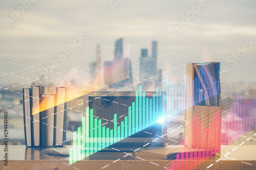 Stock market chart hologram drawn on personal computer background. Double exposure. Concept of investment.