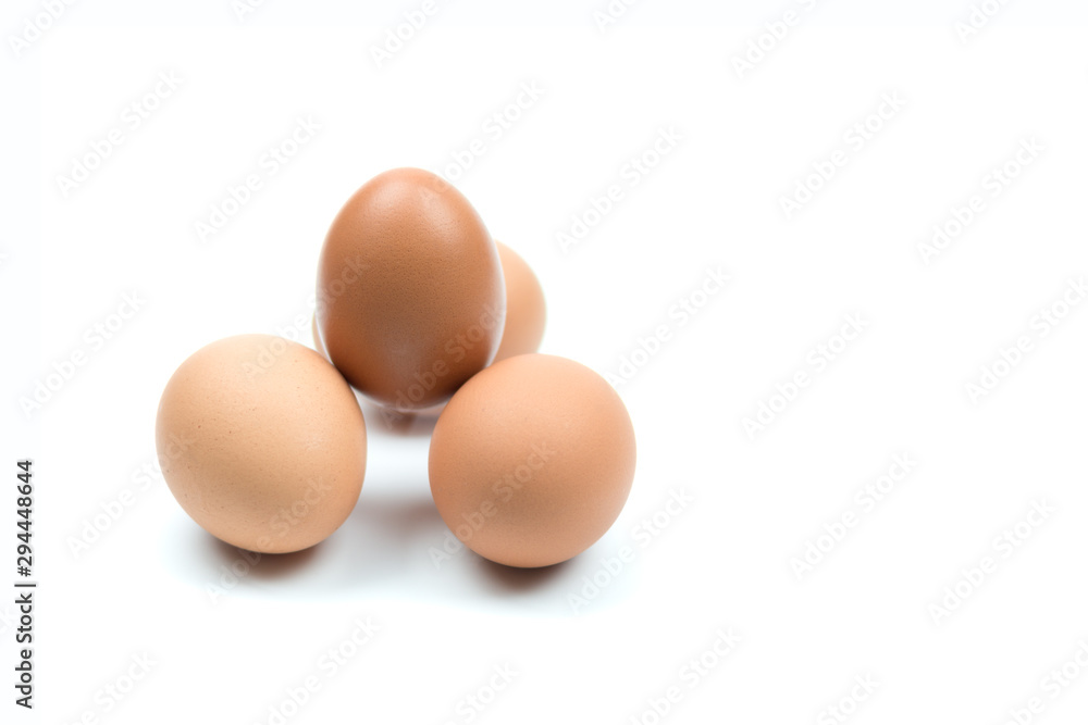 Four brown eggs separated from the white background with spaces for writing text. Four brown eggs separated from the white background with spaces for writing text.