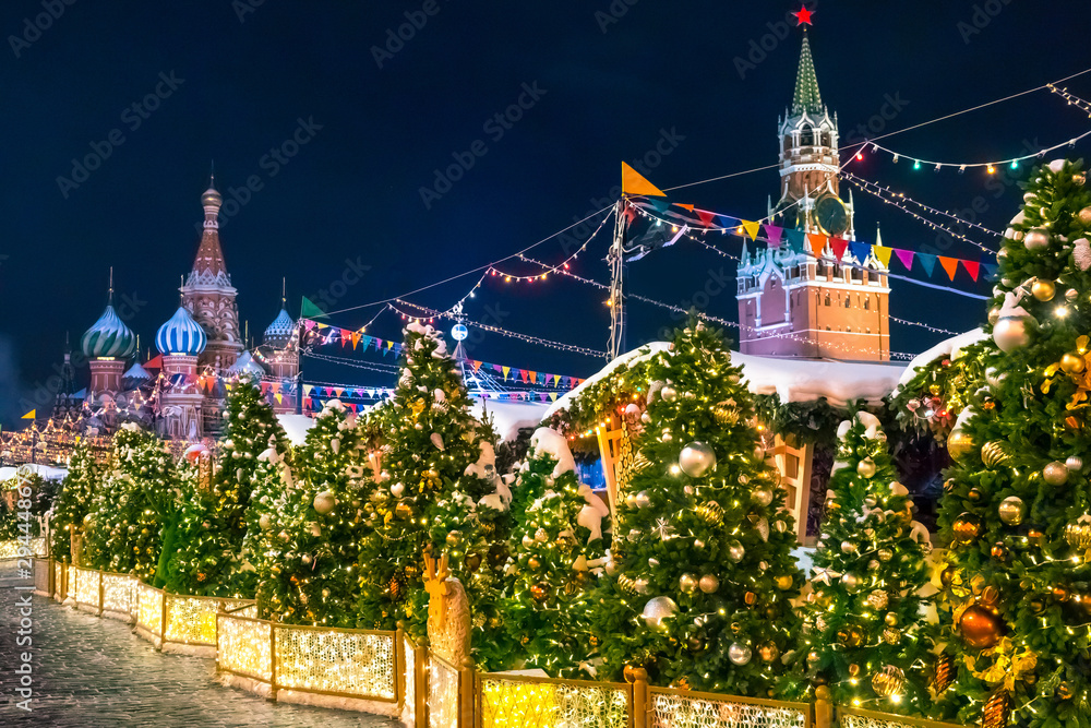 Moscow. Russia. New Year. Fair in Moscow for Christmas. St. Basil's Cathedral. Fair near the Kremlin. Spasskaya tower in the dark. Christmas trees with decorations on Red Square. Decorated city.