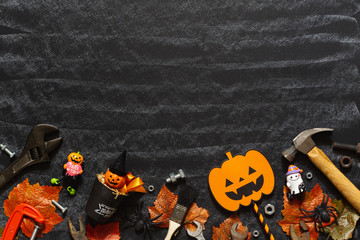 Happy Halloween day with construction DIY handy tools on black chalk board background concept. Flat lay Top view with copy space for your text.