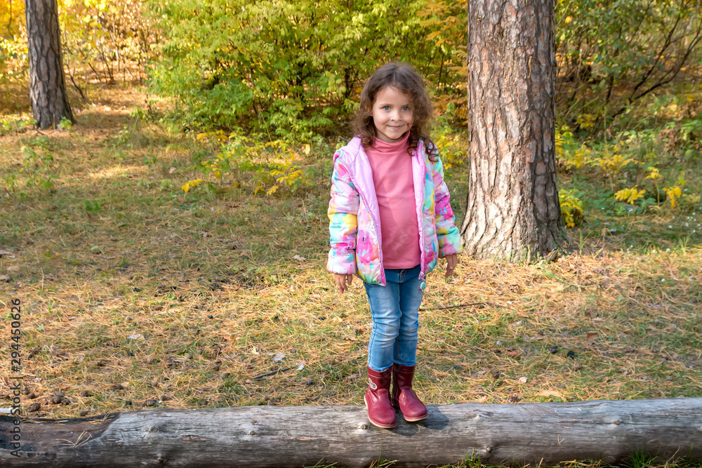 Little girl walks in the autumn forest Little girl walks in the autumn forest