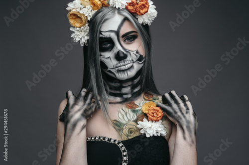 Female death with floral wreath on Halloween Day