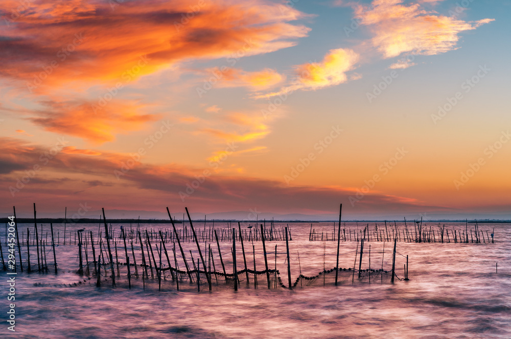 Albufera is a natural park in the province of Valencia, in the Valencian Community, Spain. It was also known by the Romans as Nacharam Stagnum and in some Arabic poems it is called Mirror of the Sun. Albufera is a natural park in the province of Valencia, in the Valencian Community, Spain. It was also known by the Romans as Nacharam Stagnum and in some Arabic poems it is called Mirror of the Sun.