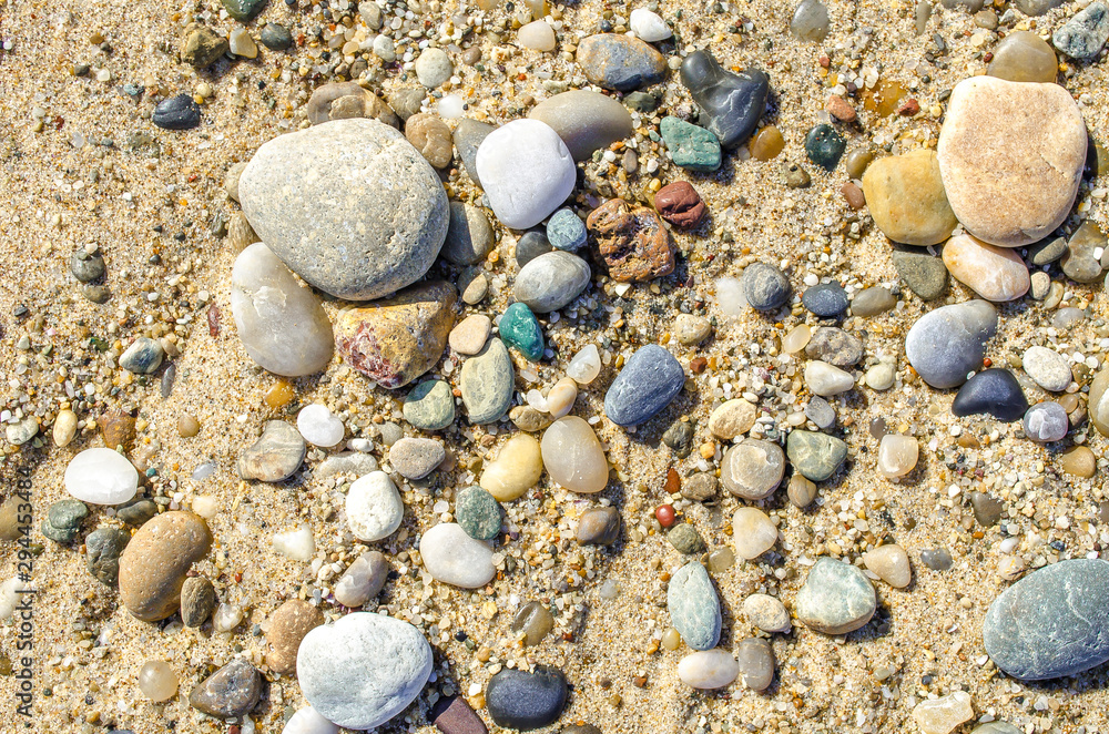 Pebble beach. Small colored sea stones close-up. Multicolor seabed. Selective focus image, copy space. Sea beach backdrop. Summer holiday concept. Pebble beach. Small colored sea stones close-up. Multicolor seabed. Selective focus image, copy space. Sea beach backdrop. Summer holiday concept.