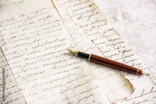 fountain pen lies on manuscript from old paper