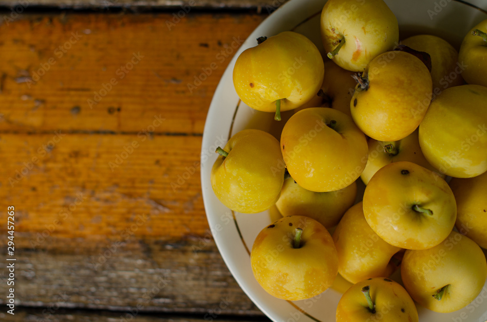 Little yellow apples on the plate. Little yellow apples on the plate.