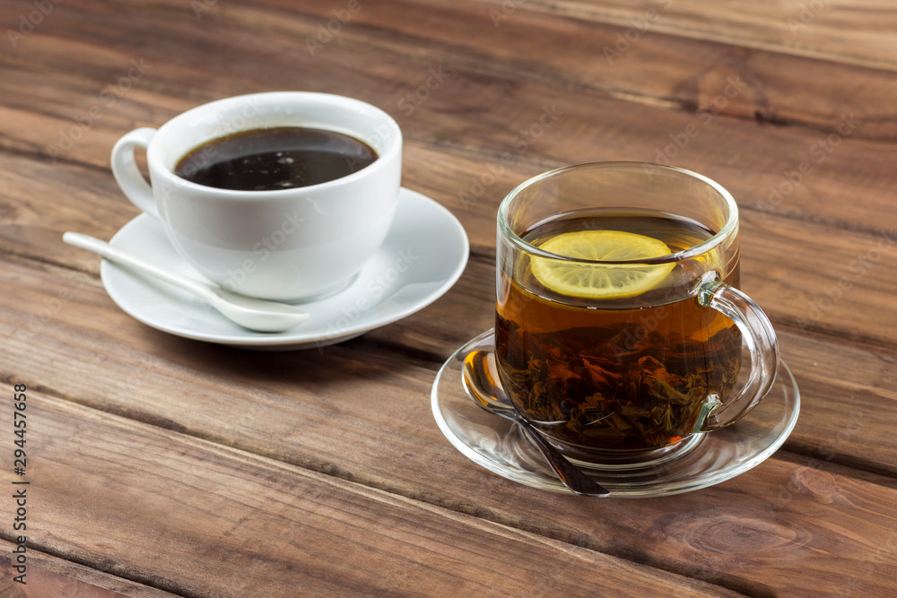 cup of tea with lemon and a cup of coffee on a wooden surface, the choice between coffee and tea cup of tea with lemon and a cup of coffee on a wooden surface, the choice between coffee and tea