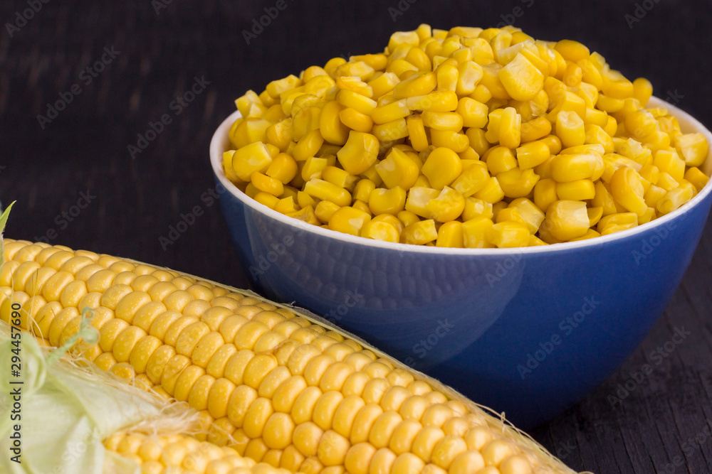 Boiled corn in a bowl. Raw Corn with Green Leaves. Boiled corn in a bowl. Raw Corn with Green Leaves.