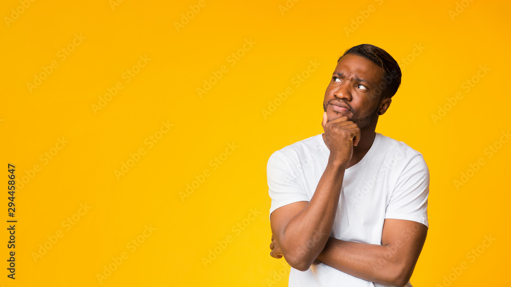 Afro Man Thinking Touching Chin Standing Over Yellow Background, Panorama Afro Man Thinking Touching Chin Standing Over Yellow Background, Panorama