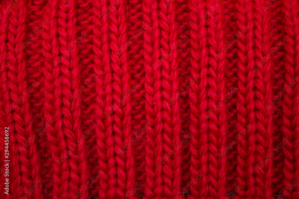 Knitted background red, close-up yarn structure