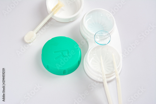 container for soft contact lenses and lens on light background, the concept of care for contact lenses