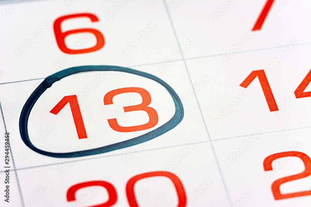 the thirteenth day of the month highlighted on the calendar with a frame close-up macro, the mark on the calendar, the thirteenth date the thirteenth day of the month highlighted on the calendar with a frame close-up macro, the mark on the calendar, the thirteenth date